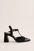 Black suede and patent T-strap pump with patent toe cap and buckle ankle strap in side view