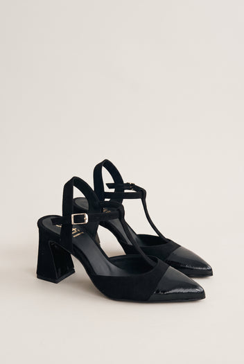 Pair of black suede T-strap pumps with patent toe caps in angled view showing flared block heels