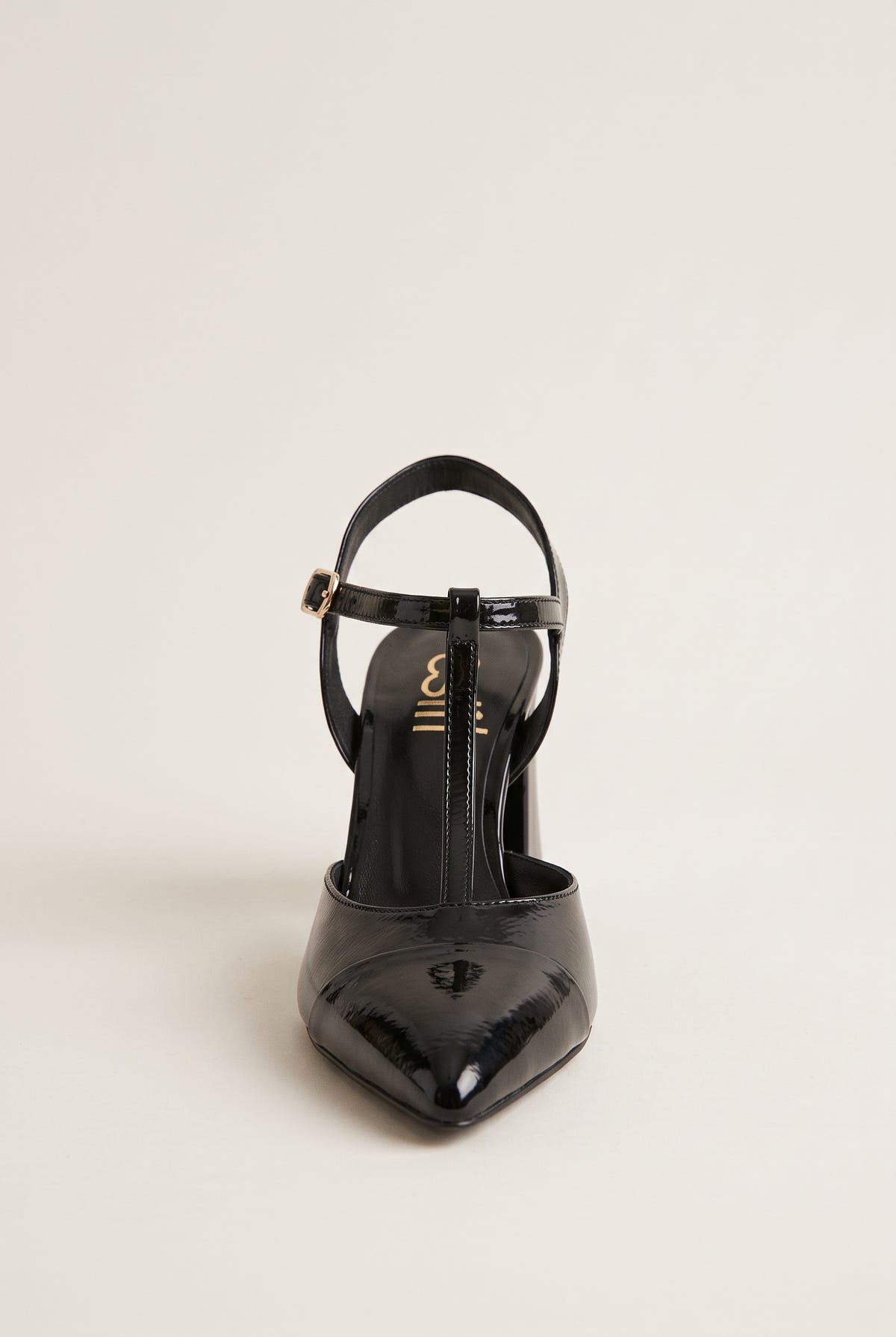 Black patent T-strap pump in front view with pointed toe and thin ankle strap over the instep