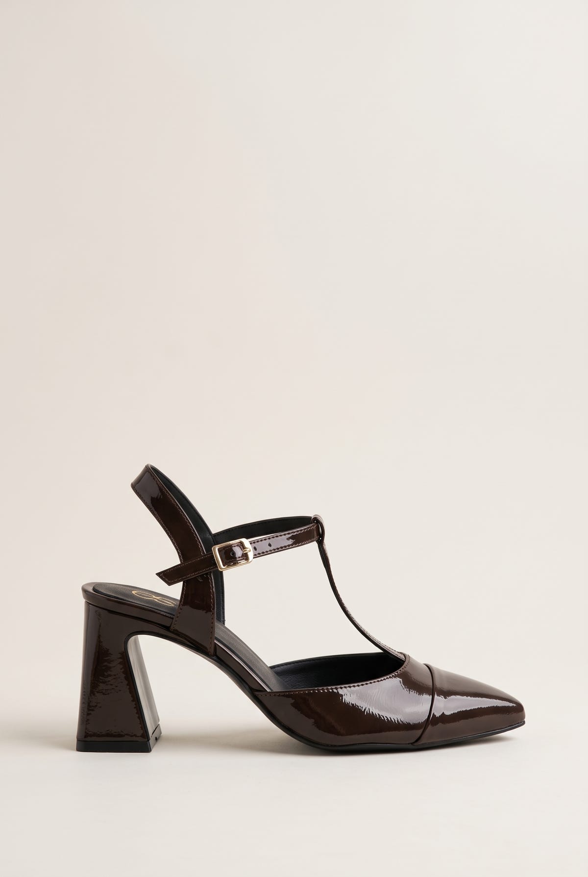 Brown patent T-strap pump with pointed toe, ankle strap buckle and flared block heel in side view