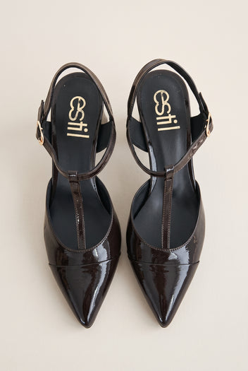 Pair of brown patent T-strap pumps in top view showing pointed toes and ankle straps