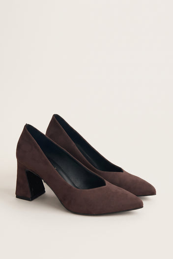 Pair of brown suede pointed-toe pumps in three-quarter view showing matte nap and block heels