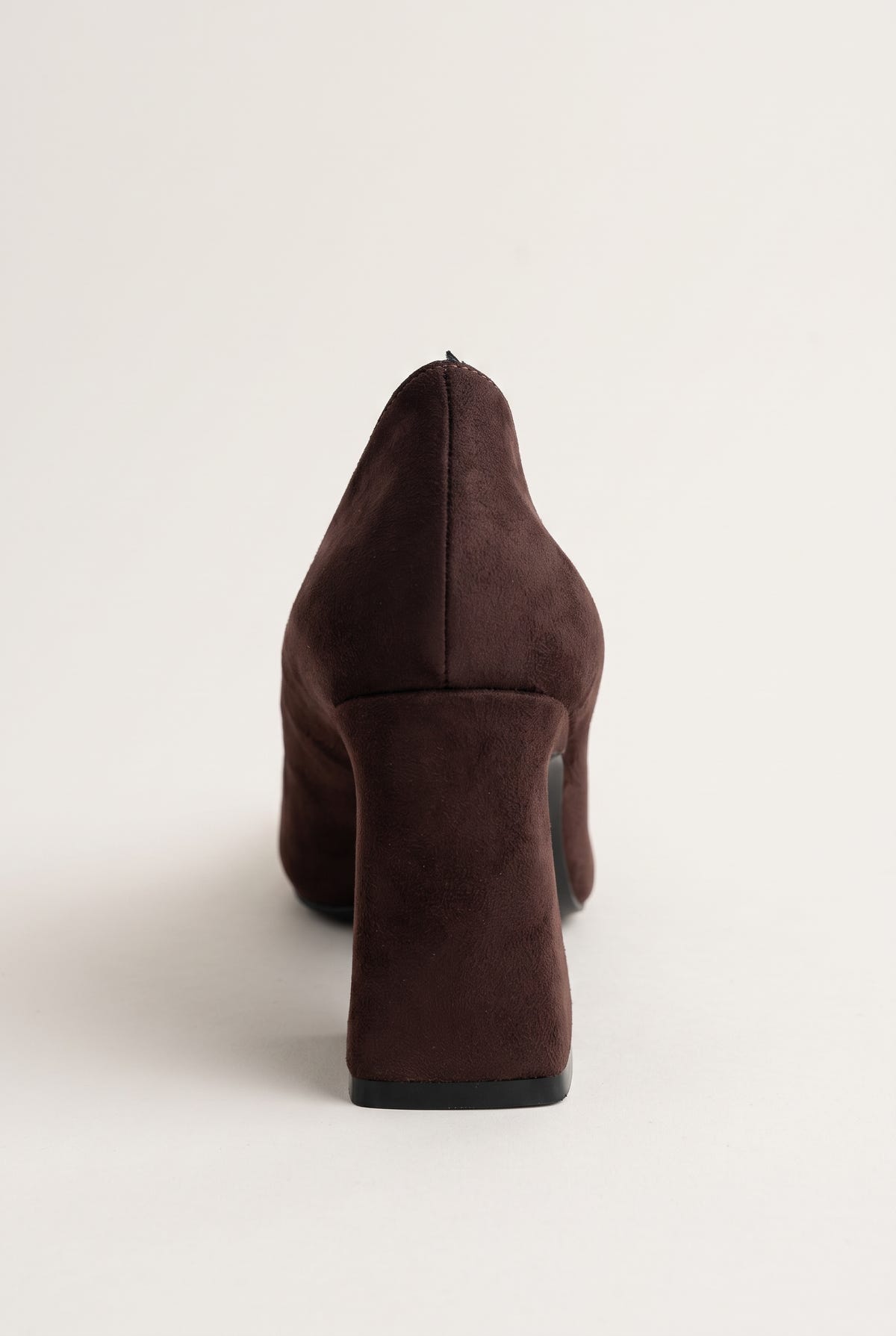 Rear view of brown suede pump showing chunky block heel, smooth back counter and thin dark sole