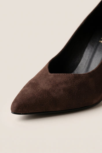 Close-up of brown suede pump vamp showing pointed toe edge, low cut and smooth suede texture
