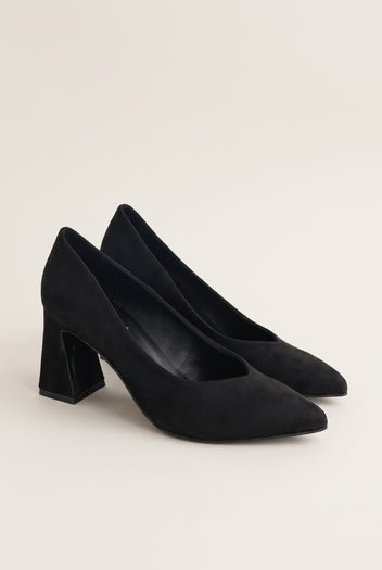 Pair of black suede pointed-toe pumps in three-quarter view showing matte nap and flared heels