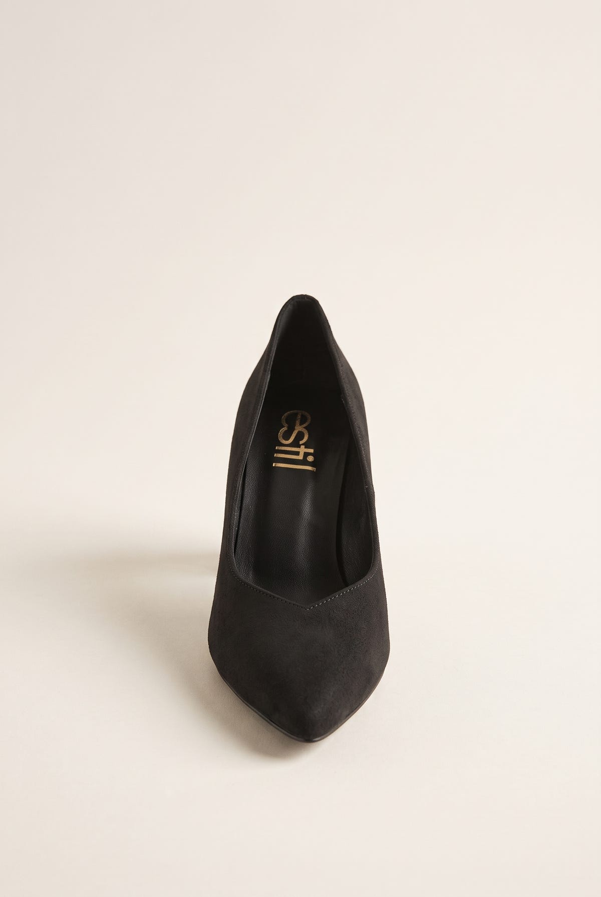 Black suede pump seen from the front showing narrow pointed toe and tapered vamp