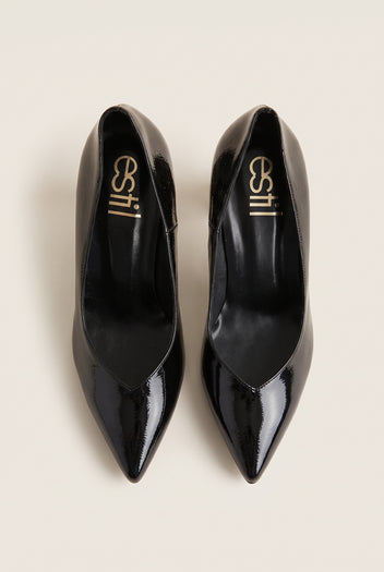 Top view of black patent pointed-toe pumps showing narrow toe shape and padded black insole