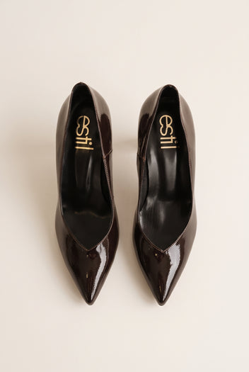 Top view of brown patent pointed-toe pumps showing narrow toe shape and padded insole