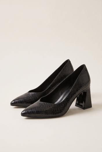 Pair of black snake-embossed pumps in angled view showing pointed toes and flared block heels