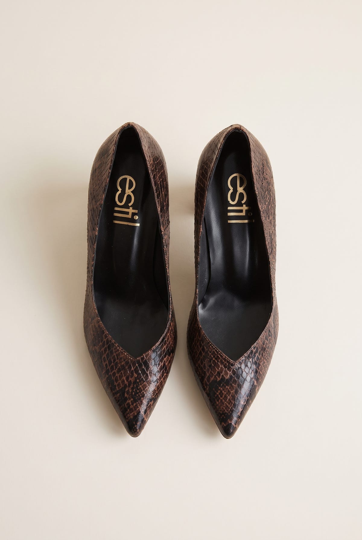 Top view of brown snake-print pointed-toe pumps showing narrow toes and padded insole