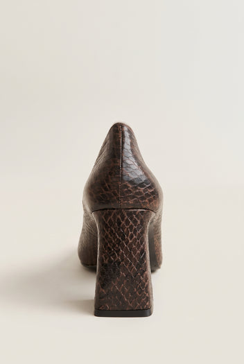 Rear view of brown snake-print pump showing textured back counter and flared block heel