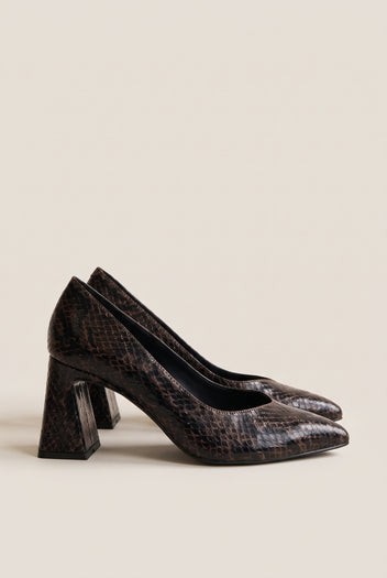 Pair of brown snake-print pointed-toe pumps in angled view showing flared block heels