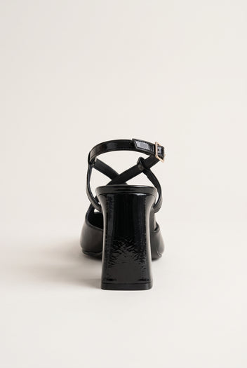 Rear view of glossy black patent block heel slingback with ankle strap buckle and sturdy heel