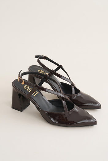 Pair of brown patent slingback pumps with pointed toes, crossed straps and block heels shown in three-quarter view
