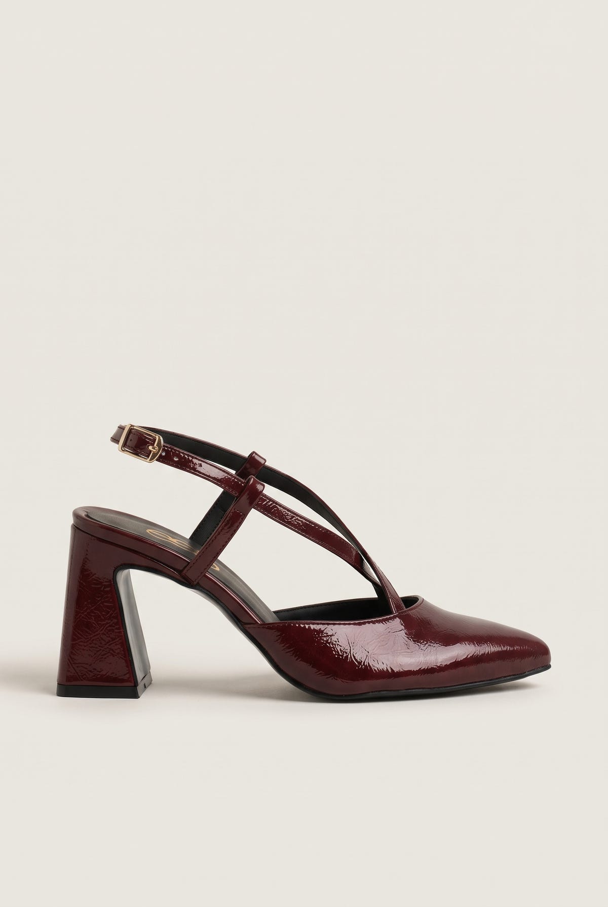 Side view of bordeaux patent block heel slingback with crossed straps and pointed toe