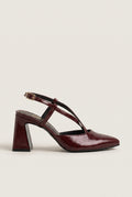 Side view of bordeaux patent block heel slingback with crossed straps and pointed toe