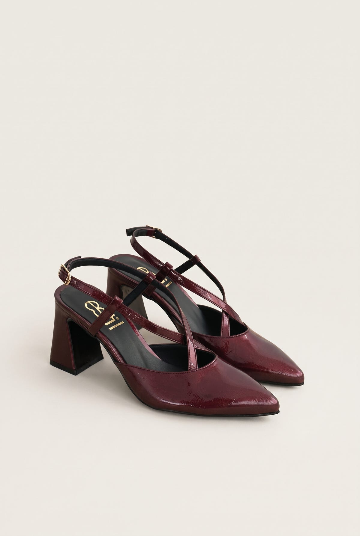 Angled pair of bordeaux patent slingback pumps with block heels and pointed toes