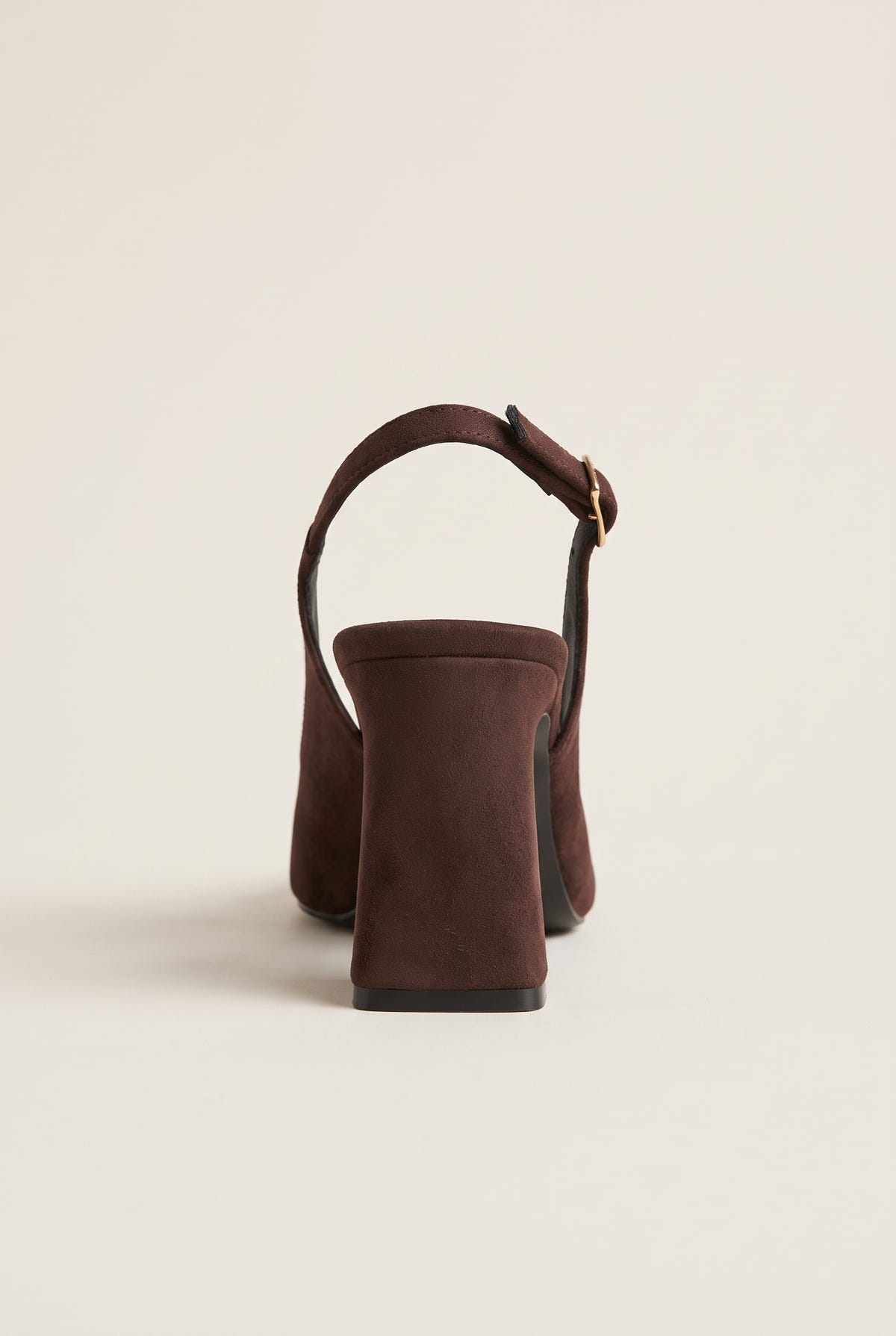 Back view of a brown suede slingback pump showing the block heel, heel counter and buckled ankle strap