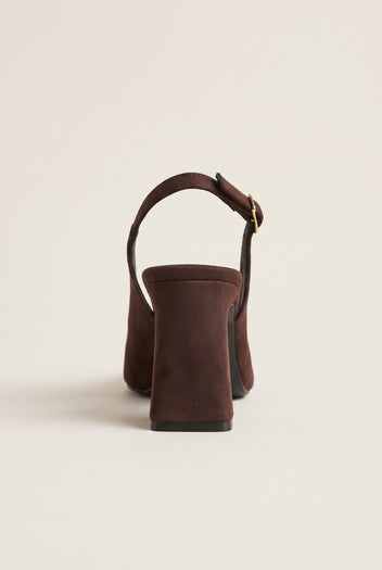 Back view of a brown suede slingback pump showing the block heel, heel counter and buckled ankle strap