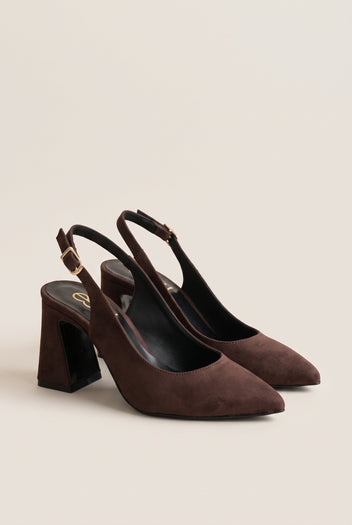 Pair of brown suede slingback pumps with pointed toes and block heels, tilted on a beige wall to show both shoes