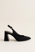 Side view of a black suede slingback pump with a pointed toe, block heel and gold buckle on the ankle strap