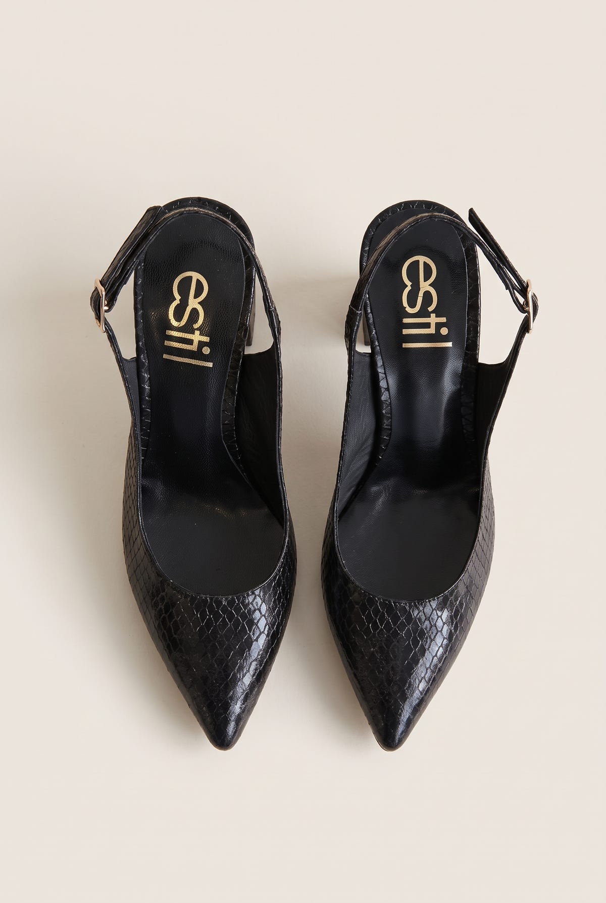 Top view of black snake-effect slingback pumps with buckled straps, pointed toes and black insoles