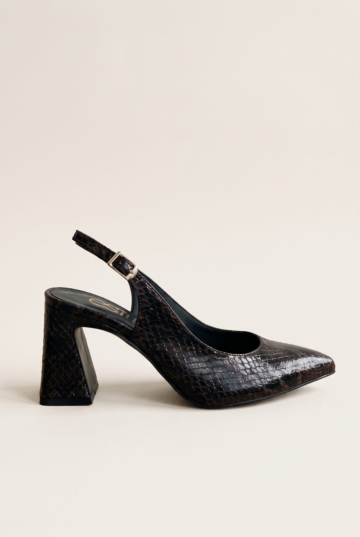 Side view of a brown snake-print slingback pump with a pointed toe, flared block heel and gold buckled ankle strap