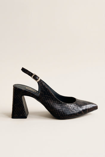 Side view of a brown snake-print slingback pump with a pointed toe, flared block heel and gold buckled ankle strap