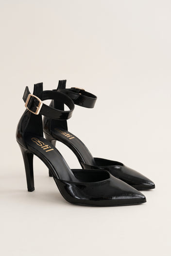 Pair of black patent pointed-toe stiletto pumps with double ankle straps and gold buckles, viewed from the front and side
