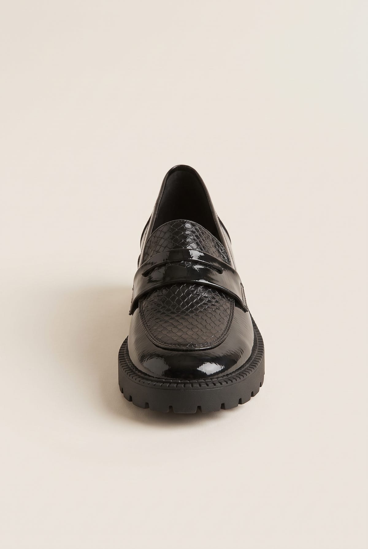 Front view of single black patent chunky loafer with narrow snake-embossed penny strap