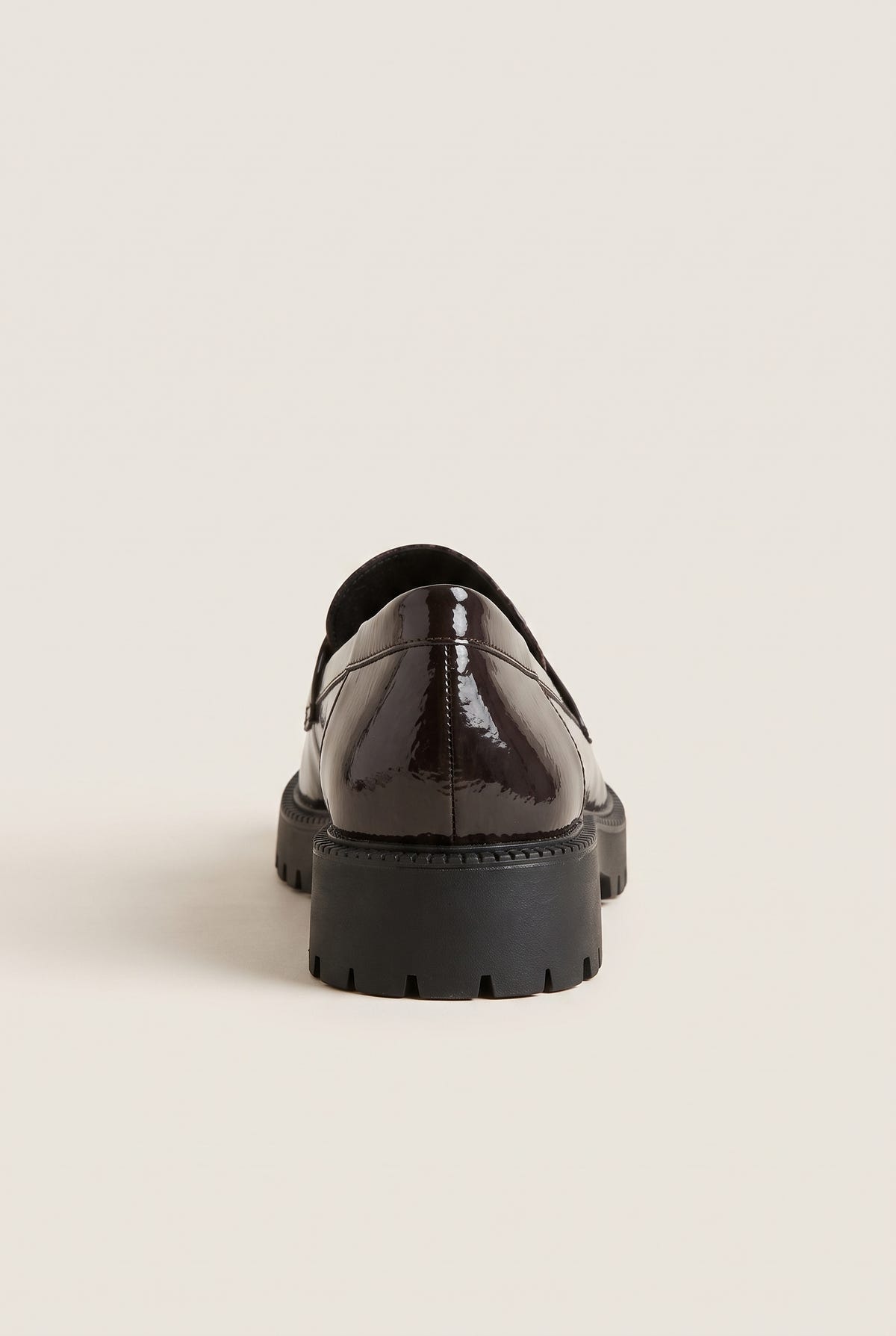 Back view of brown patent chunky loafer with dark lug sole and glossy smooth heel counter