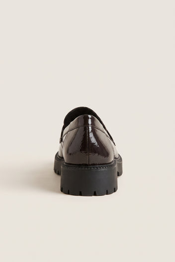 Back view of brown patent chunky loafer with dark lug sole and glossy smooth heel counter
