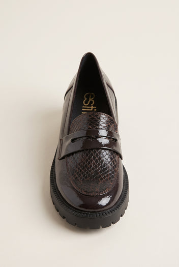 Brown patent snake-embossed chunky loafer seen from the front three-quarter angle with penny strap