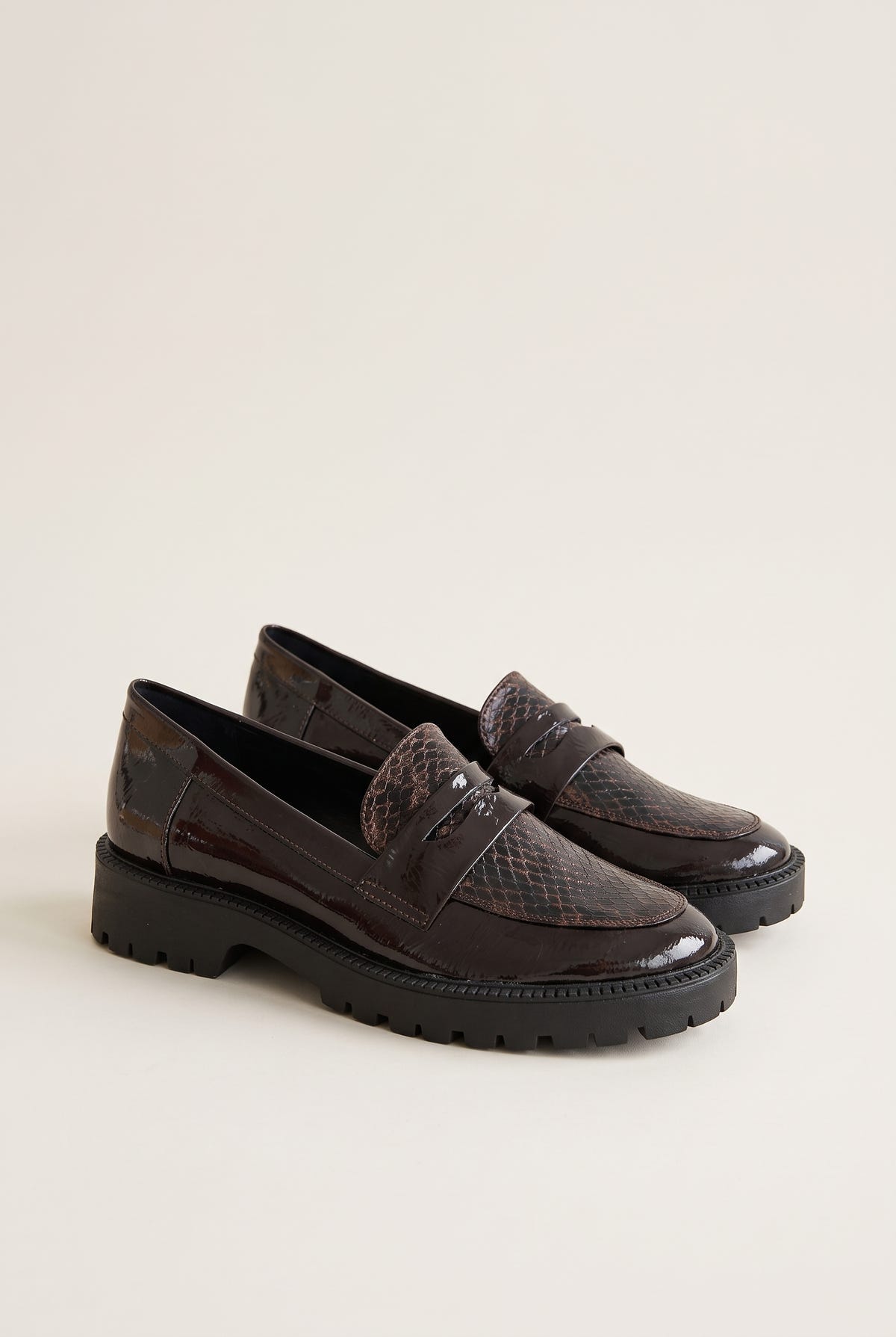 Pair of brown patent snake-embossed chunky loafers with penny strap, angled three-quarter view
