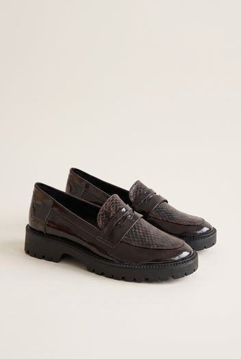 Pair of brown patent snake-embossed chunky loafers with penny strap, angled three-quarter view