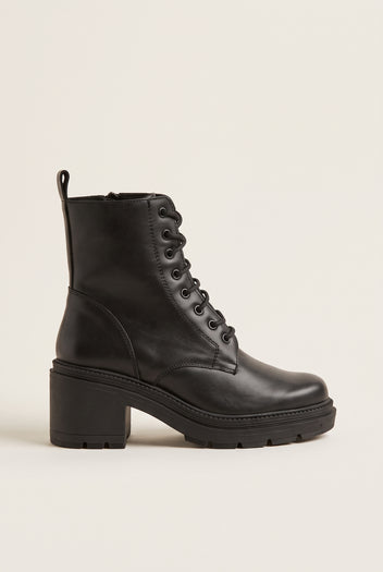 Black leather lace-up ankle boot with black laces, side zip, back pull loop and a chunky block heel, side view on white