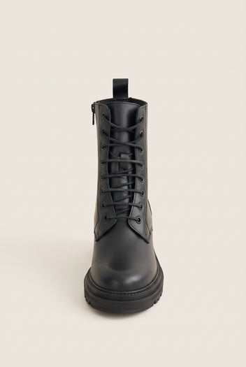 Front view of a black leather lace-up ankle boot with black laces, side zip, pull tab and a chunky lugged sole