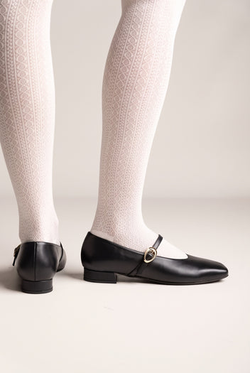 Black leather Mary Jane shoes with square toe, gold buckle strap and low block heel, worn on model, back and side view