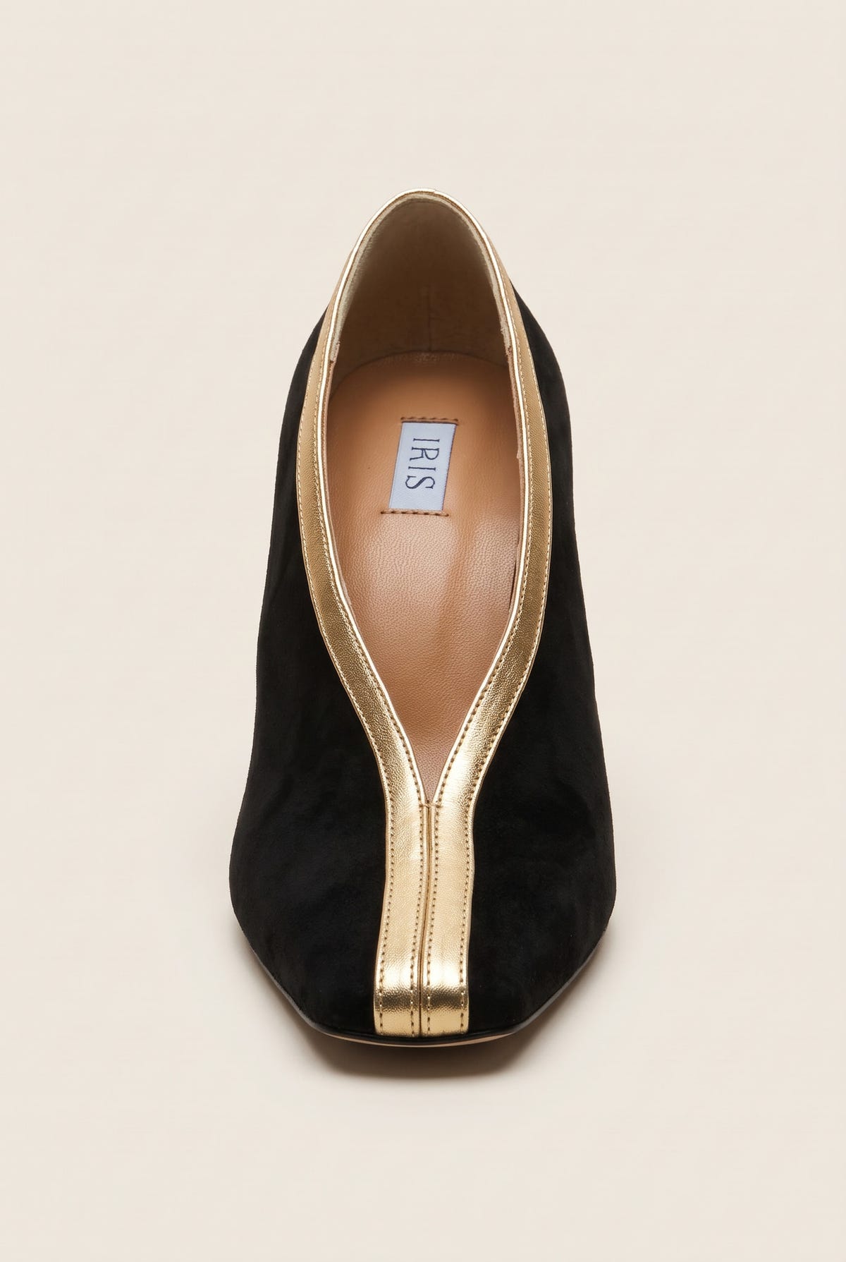 Top view of a black suede pump with a square toe and a V-shaped gold metallic trim along the opening