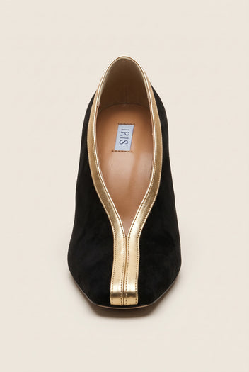 Top view of a black suede pump with a square toe and a V-shaped gold metallic trim along the opening