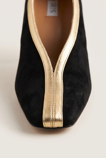 Close-up of a black suede square toe with gold metallic trim running down the center of the vamp