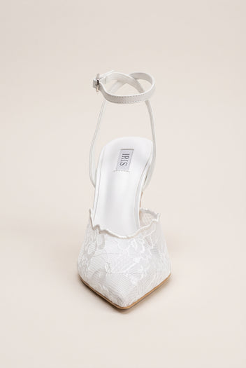 Front view of a white lace pump with ankle strap loops rising behind the lace-trimmed vamp
