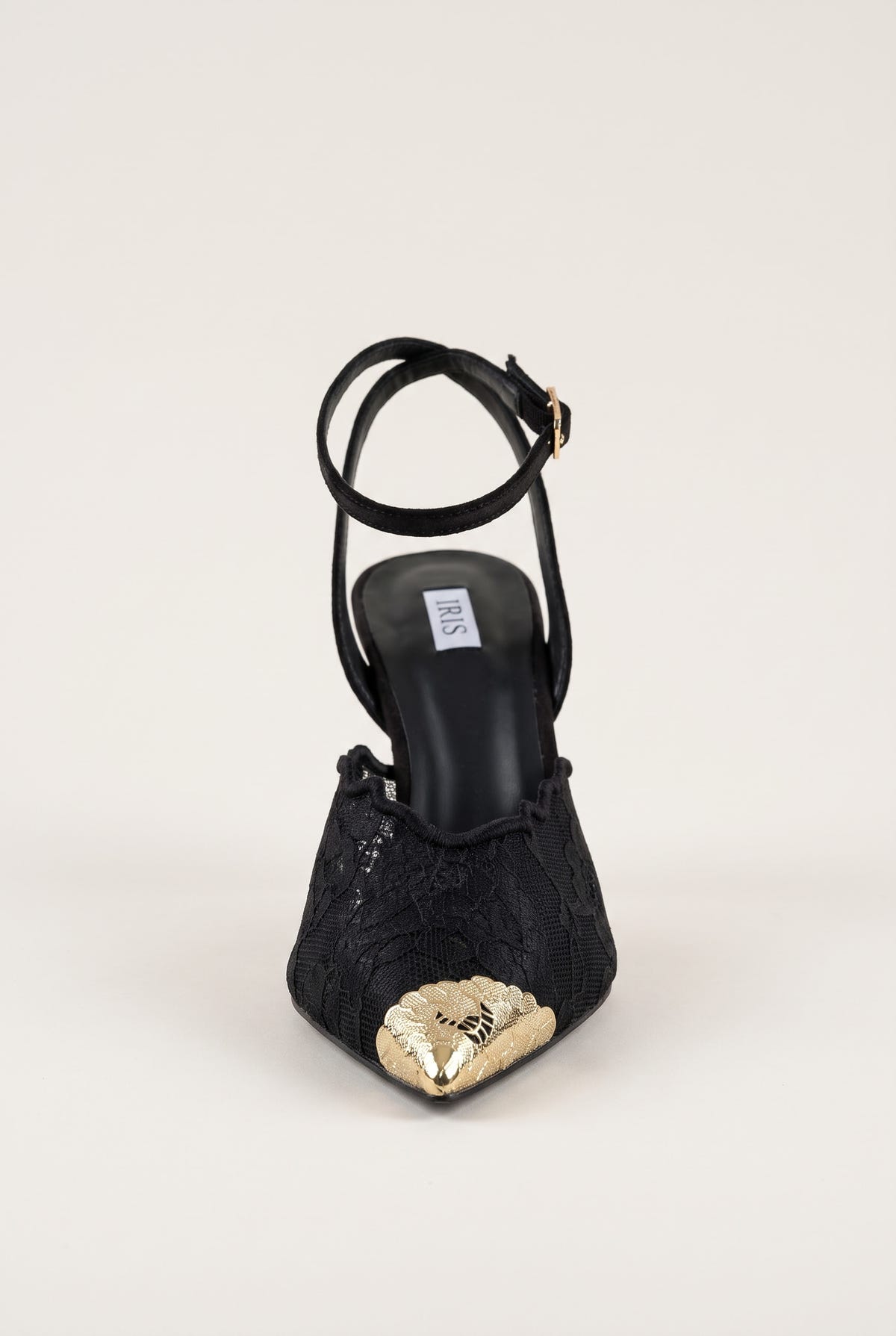 Rear angle of black lace stiletto pump showing gold toe cap and lace panel over pointed toe