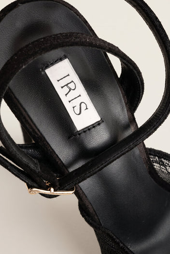 Close-up of black lace stiletto insole and thin ankle strap with gold-toned buckle at the side