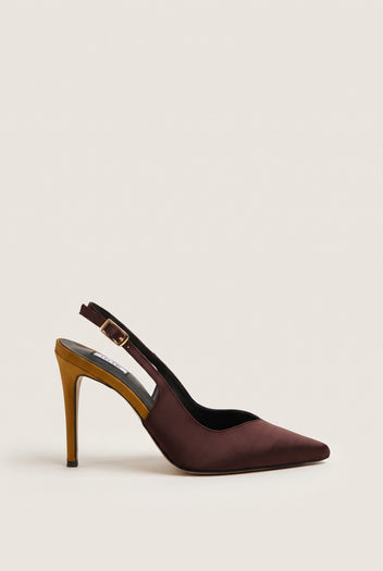 Side view of a brown satin slingback pump with a pointed toe, gold buckle strap and a slim gold stiletto heel