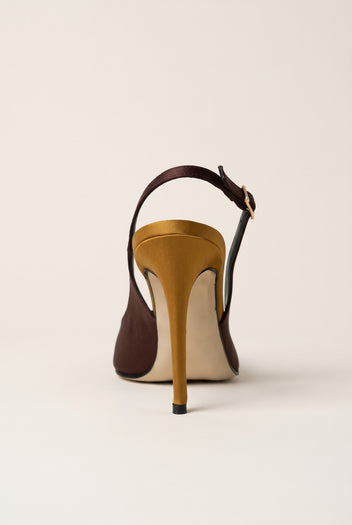 Back view of a brown satin slingback pump with a gold buckle strap and a tall gold stiletto heel