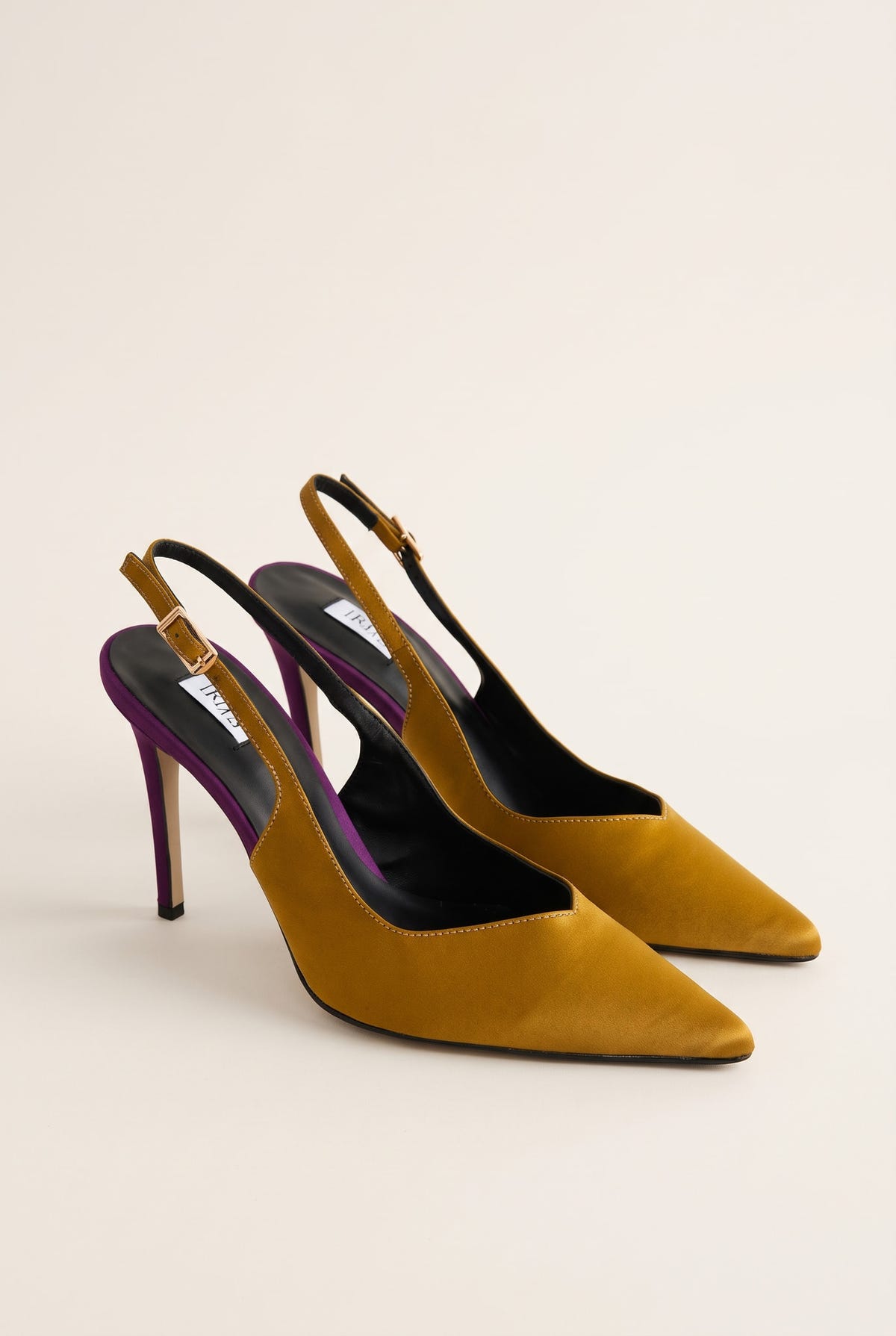 Pair of olive satin slingback pumps seen at an angle with purple heels and buckled ankle straps