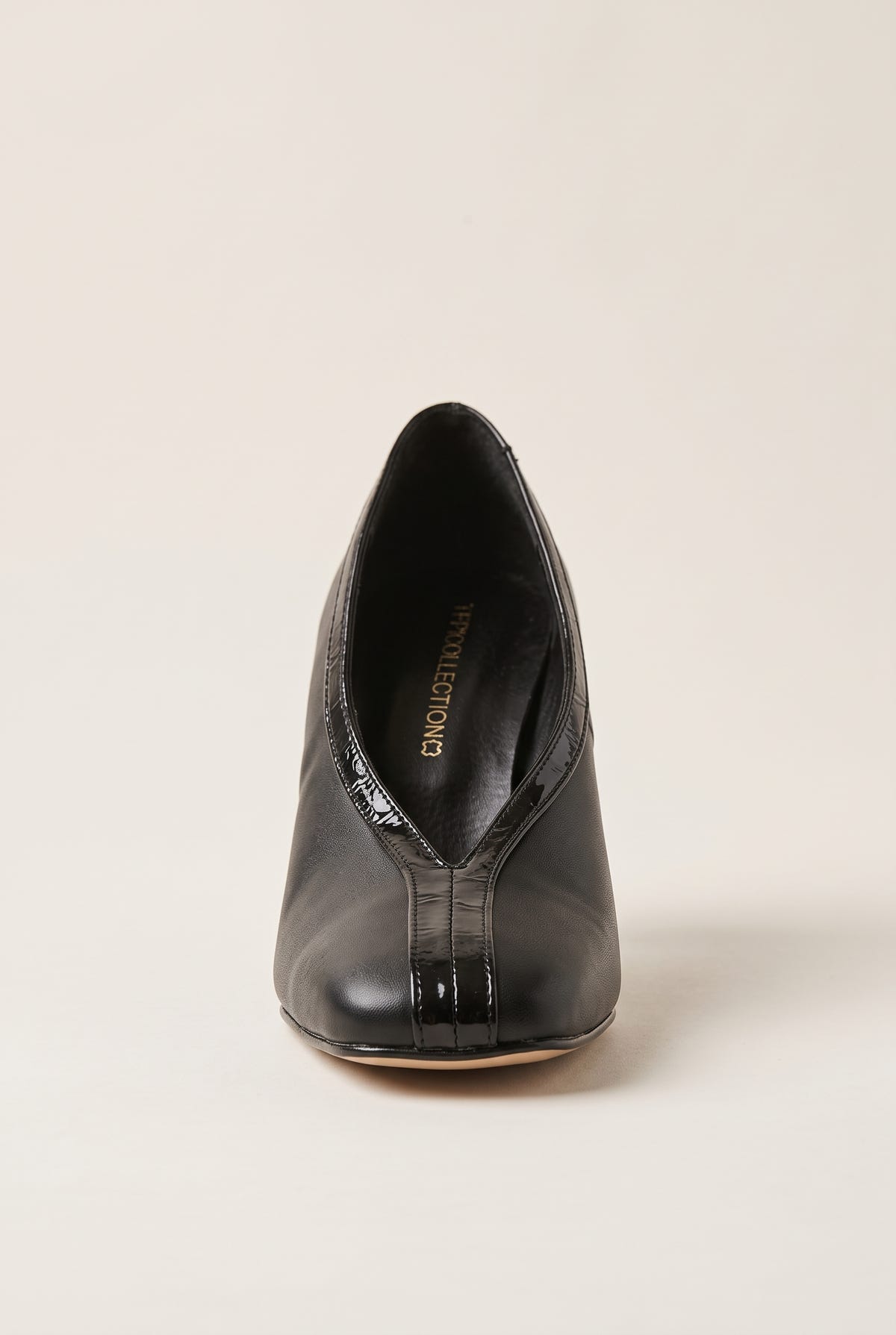 Front view of black court shoe with square toe, V-cut vamp and glossy croc-effect trim down the centre