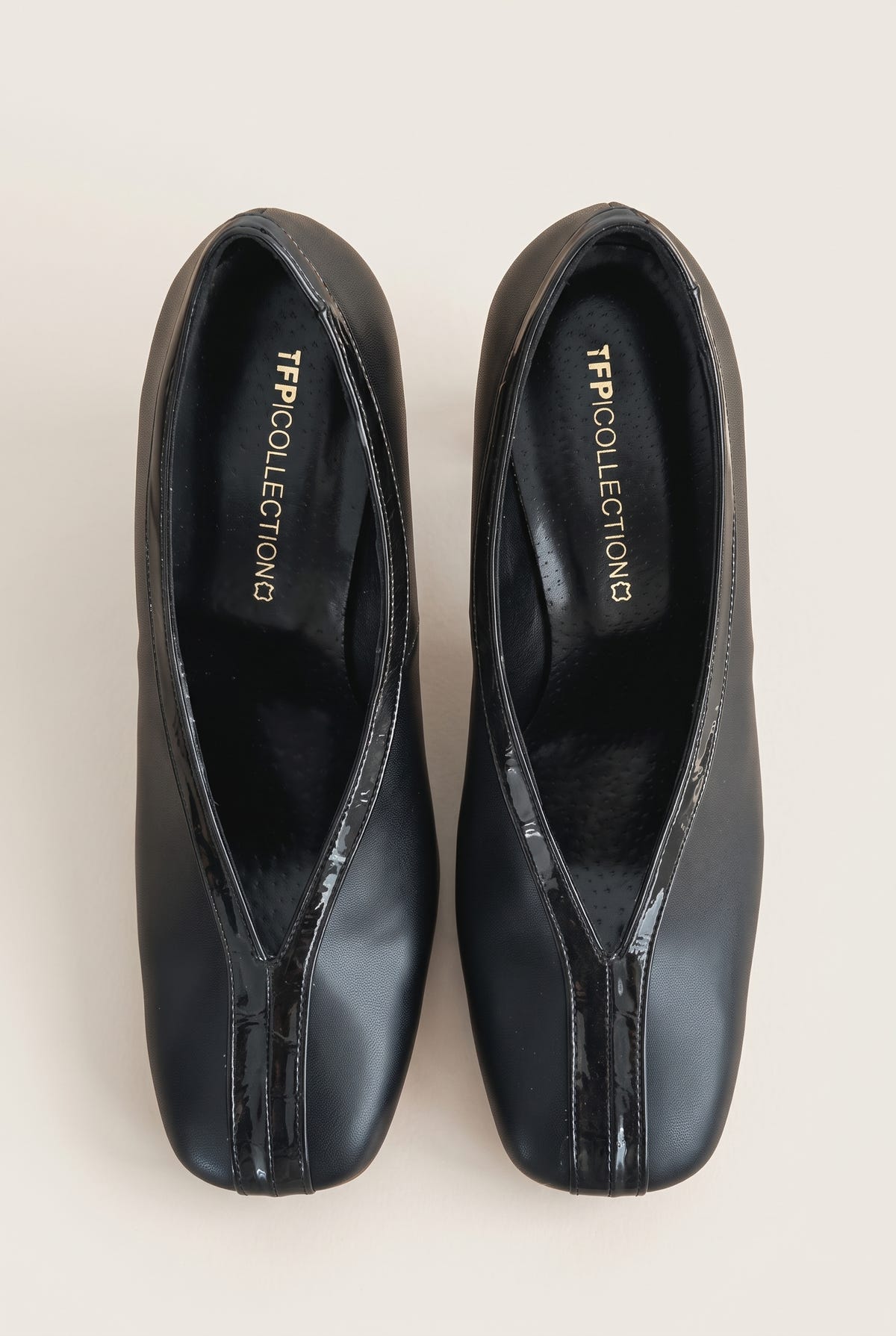 Top view of a pair of black court shoes with V-cut vamps, croc-effect trim and padded insoles