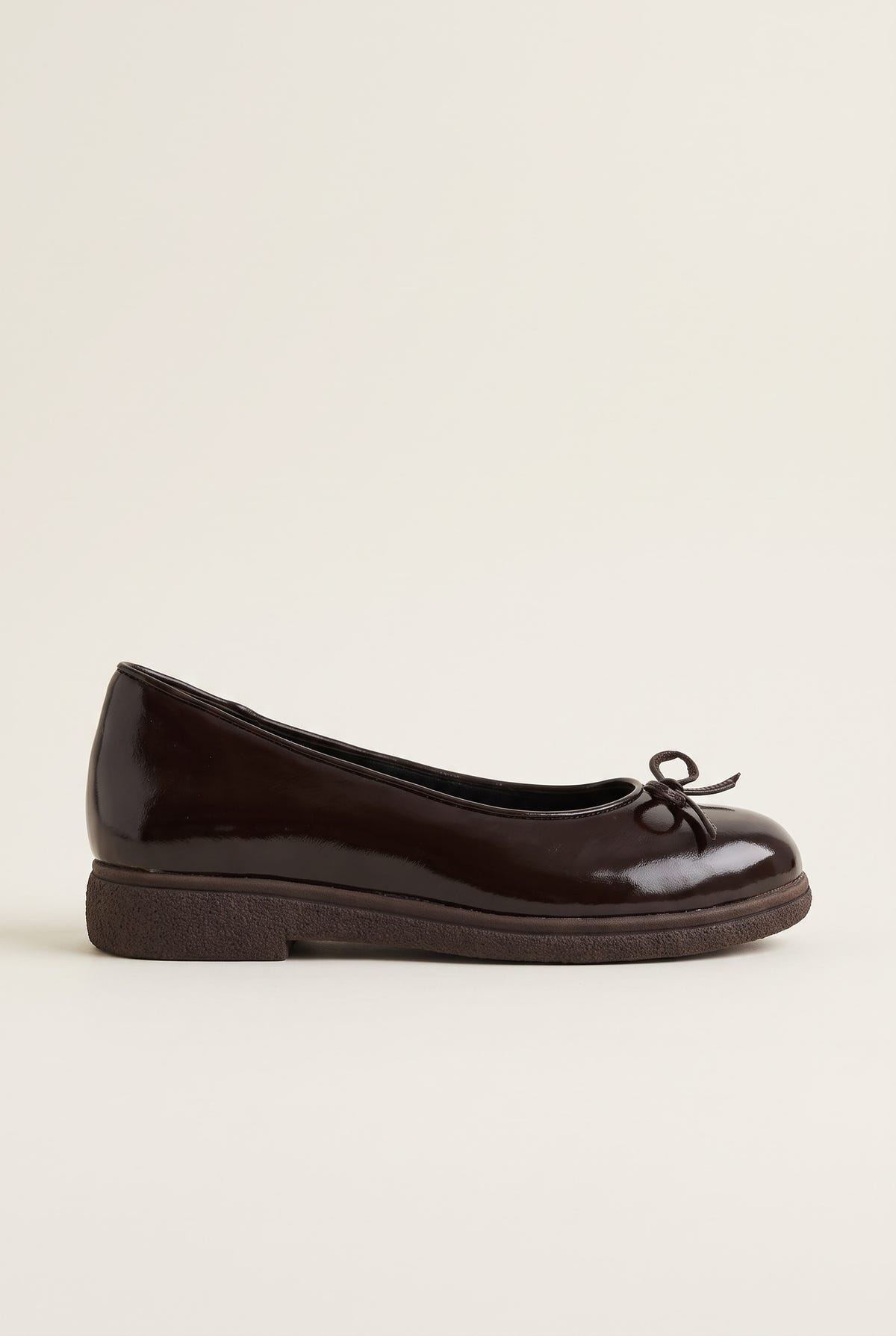 side view of one glossy dark brown patent ballet flat with a low thin sole and a small bow at the vamp